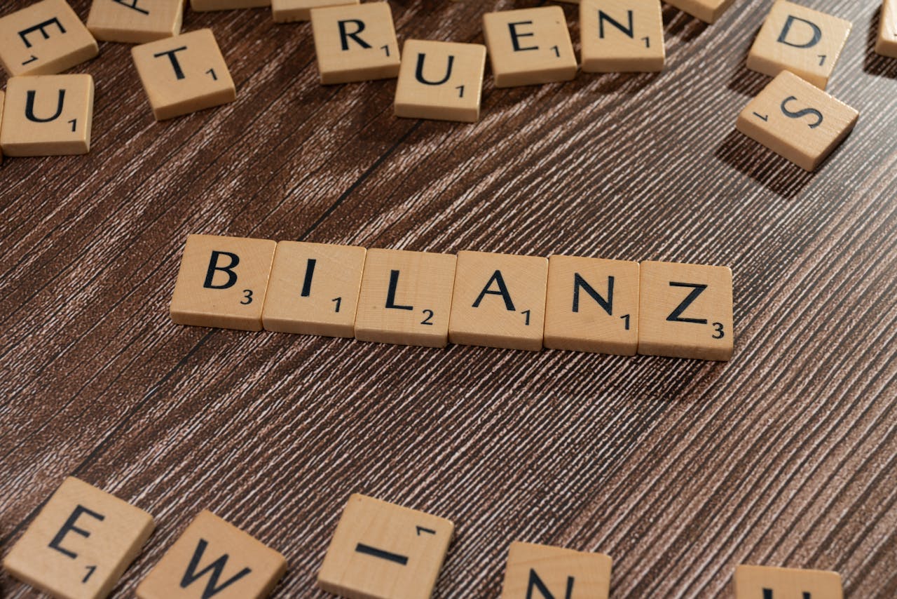 Crafting Captivating Headlines: Your awesome post title goes here Scrabble tiles spelling Bilanz on a wooden surface, symbolic of financial balance.